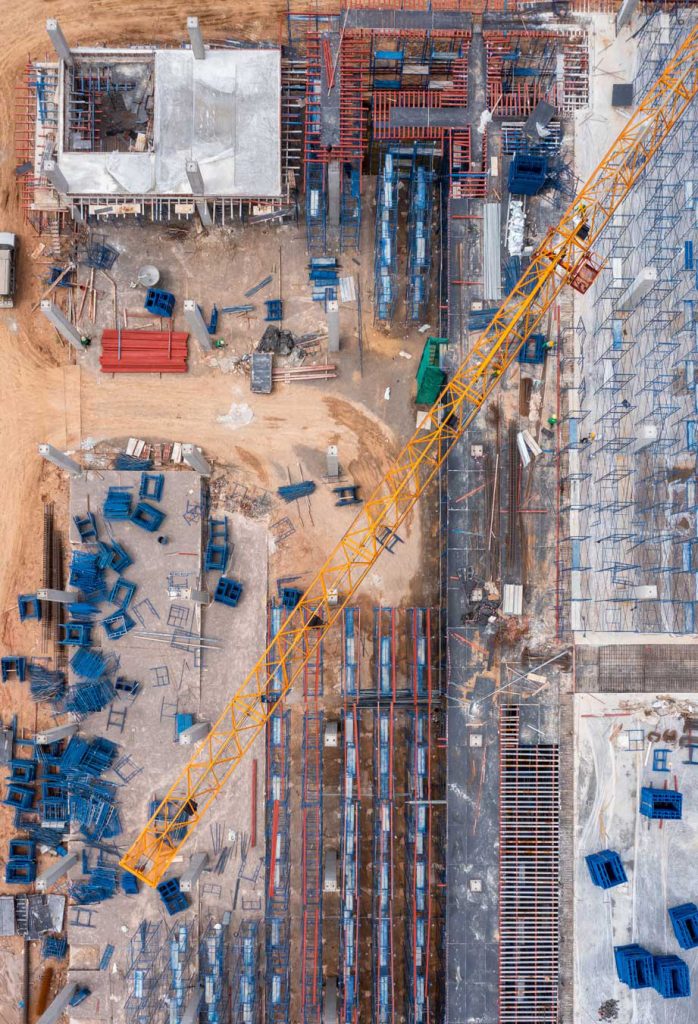 Aerial view construction site with tower crane and building cons